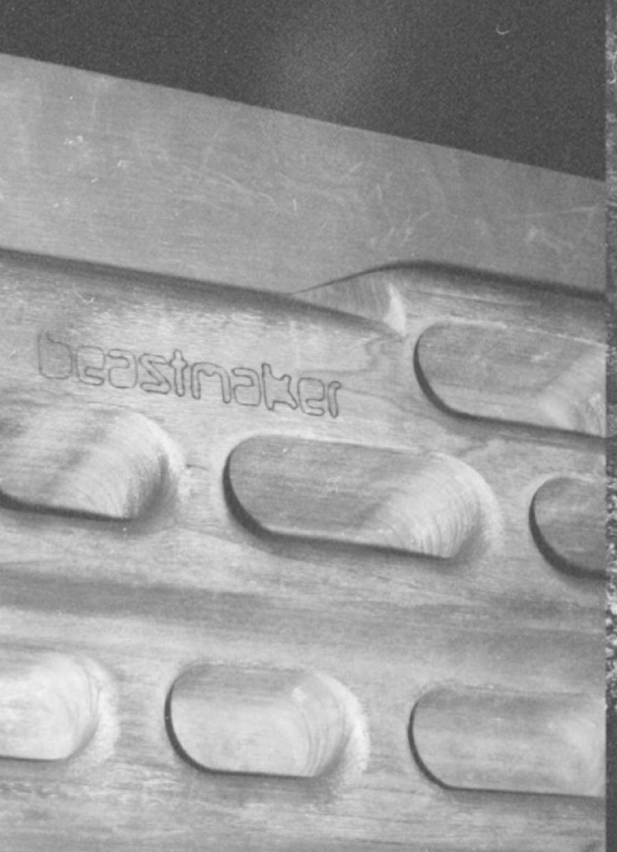 Close-up of a wooden training board with carved rounded holds